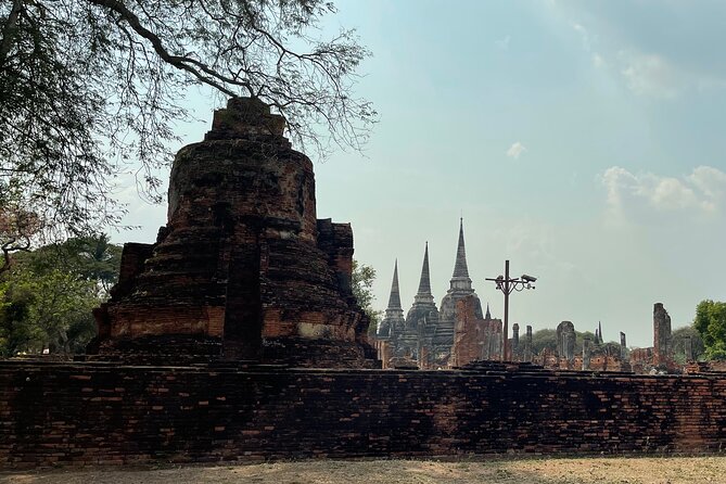 Ayutthaya Historical Old Capital day Tour from Bangkok - Wat Mahathat: the Buddha head in tree roots photo moment