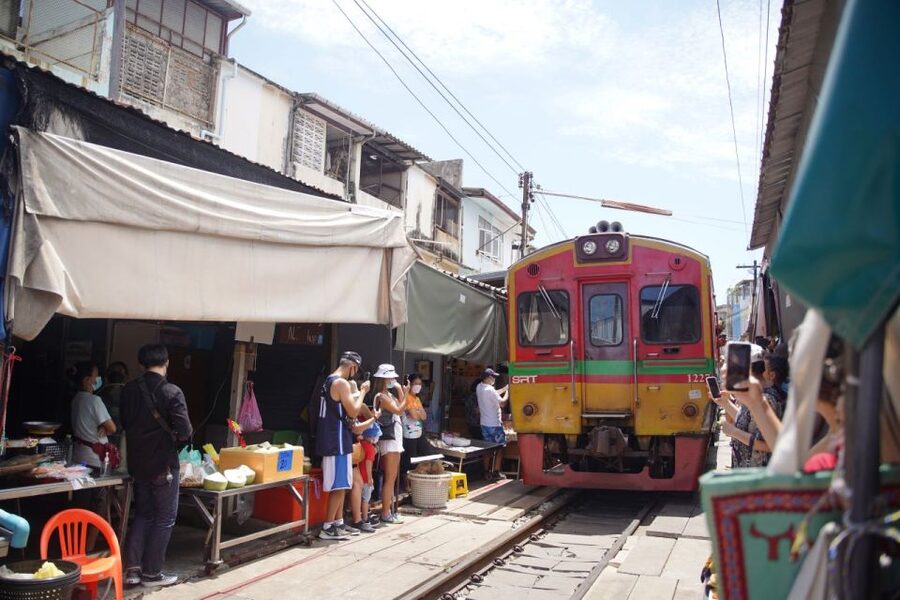 Bangkok: Maeklong Railway Market and Floating Market Tour - Damnoen Saduak Floating Market by paddle boat, canal views, and food stops