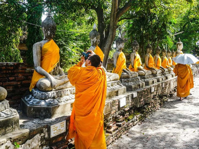 From Bangkok: Ayutthaya Heritage Tour with Sunset Boat Ride - Meeting at Shangri-La or Saphan Taksin, then settling into an air-conditioned ride