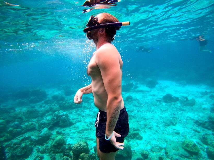 From Koh Lanta: Koh Haa & Koh Rok Snorkel Tour by Speedboat - Koh Haa snorkeling: swimming between the islands and chasing colorful coral