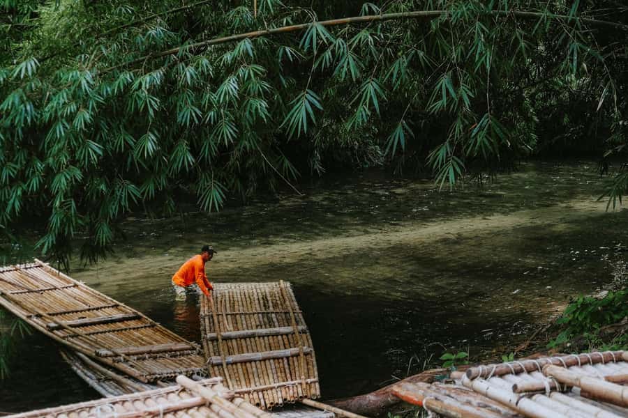 Khao Sok: Private Bamboo Rafting & Jungle Cave Temple Tour - The traditional bamboo raft, plus fish that steal the show