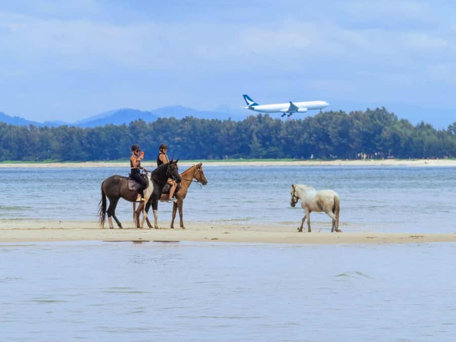 Phuket Beach Horseback Adventure - Nai Yang Beach riding with a sky full of planes