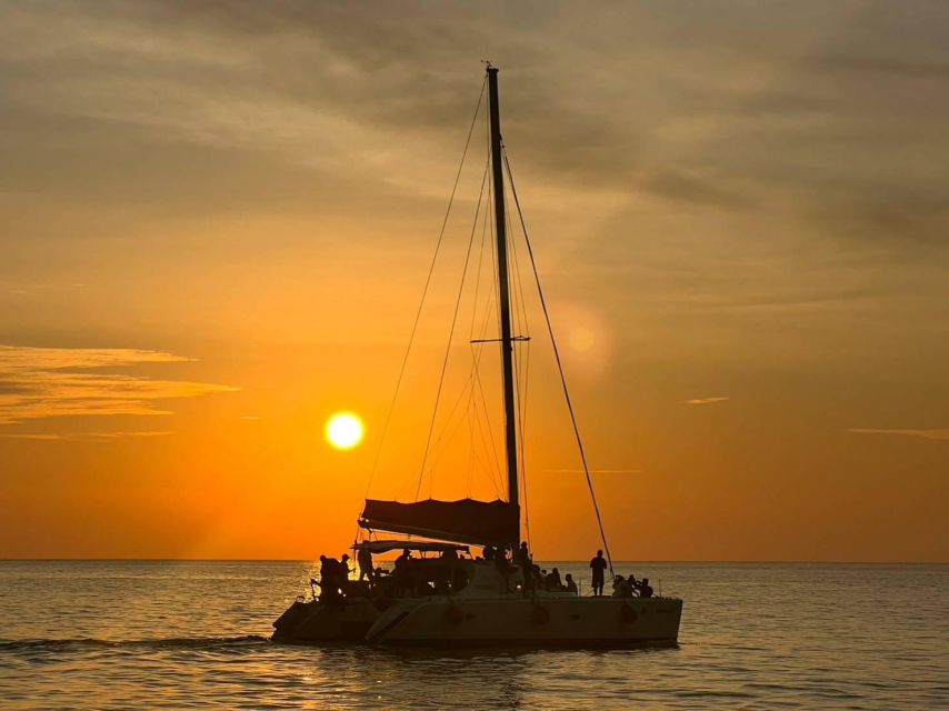 Phuket: Coral Island & Sunset Dinner by Sailing Catamaran - Coral Island time: beaches, snorkeling, and thrill options (when conditions allow)
