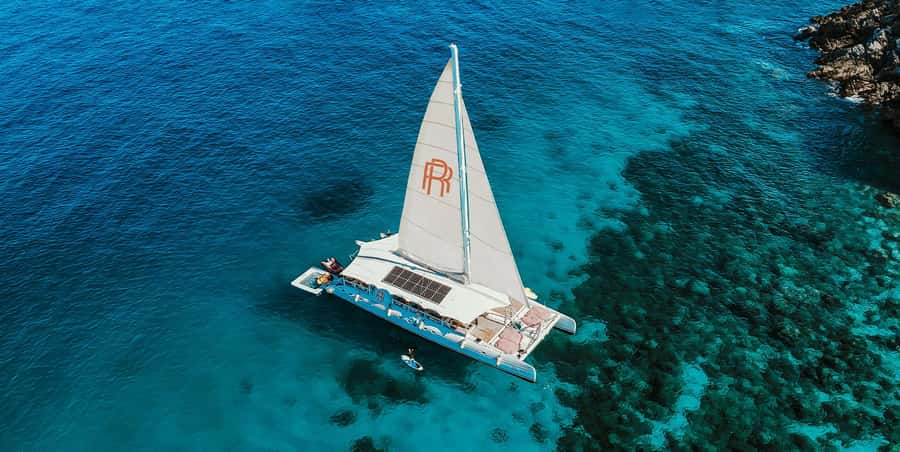 Phuket: Coral & Racha Sunset Luxury Catamaran Party Cruise - Coral Island at Banana Beach: Sun, Snorkels, and Water-Slide Energy